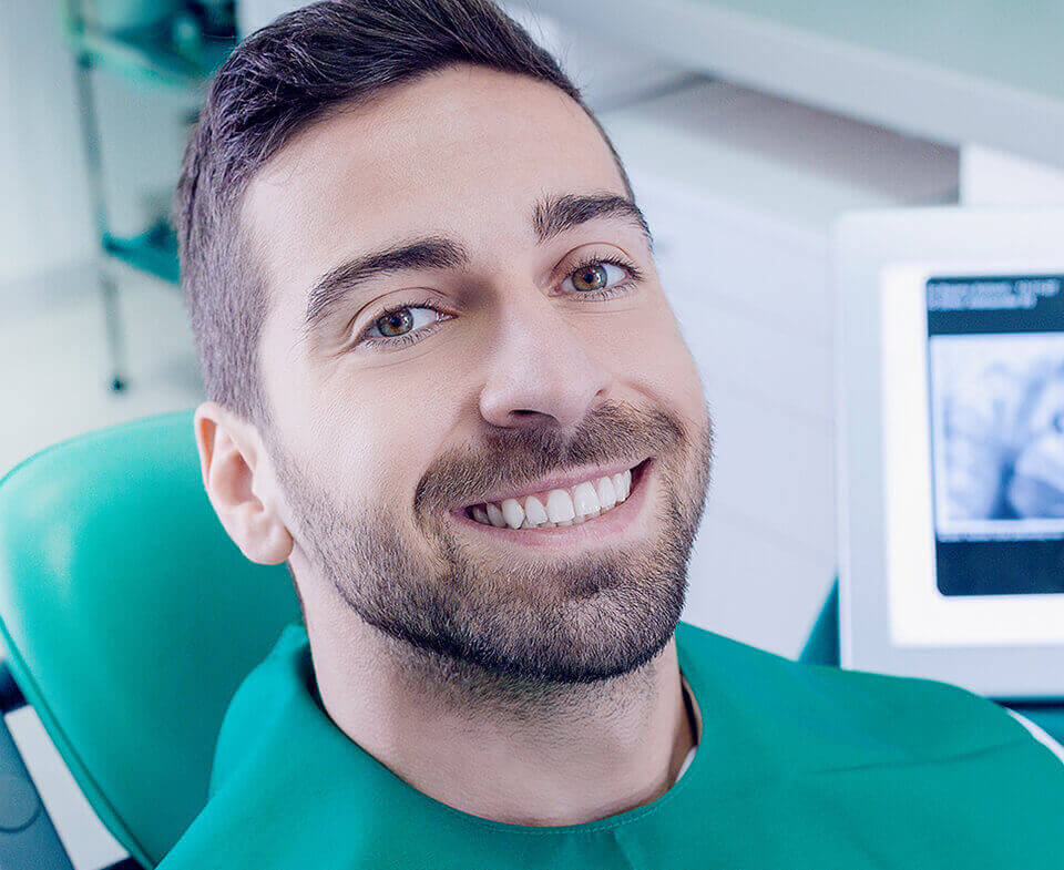 man in dental chair smiling