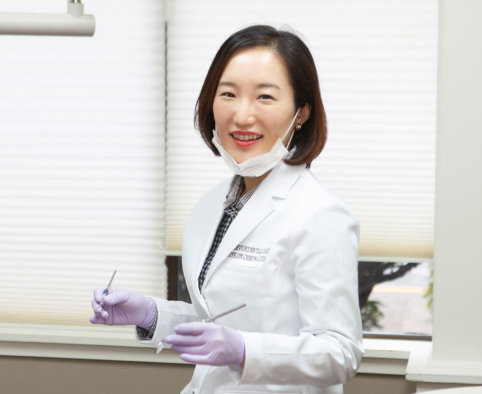 Dr Cheong holding dental tools in Bellevue