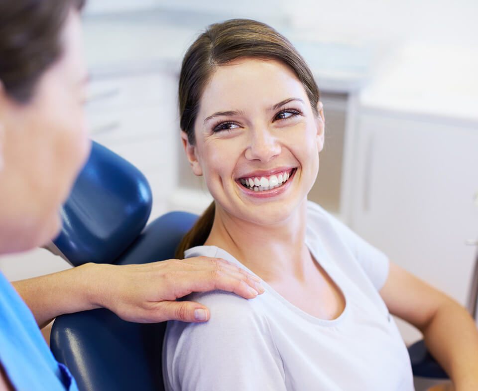 woman smiling at dental assistant