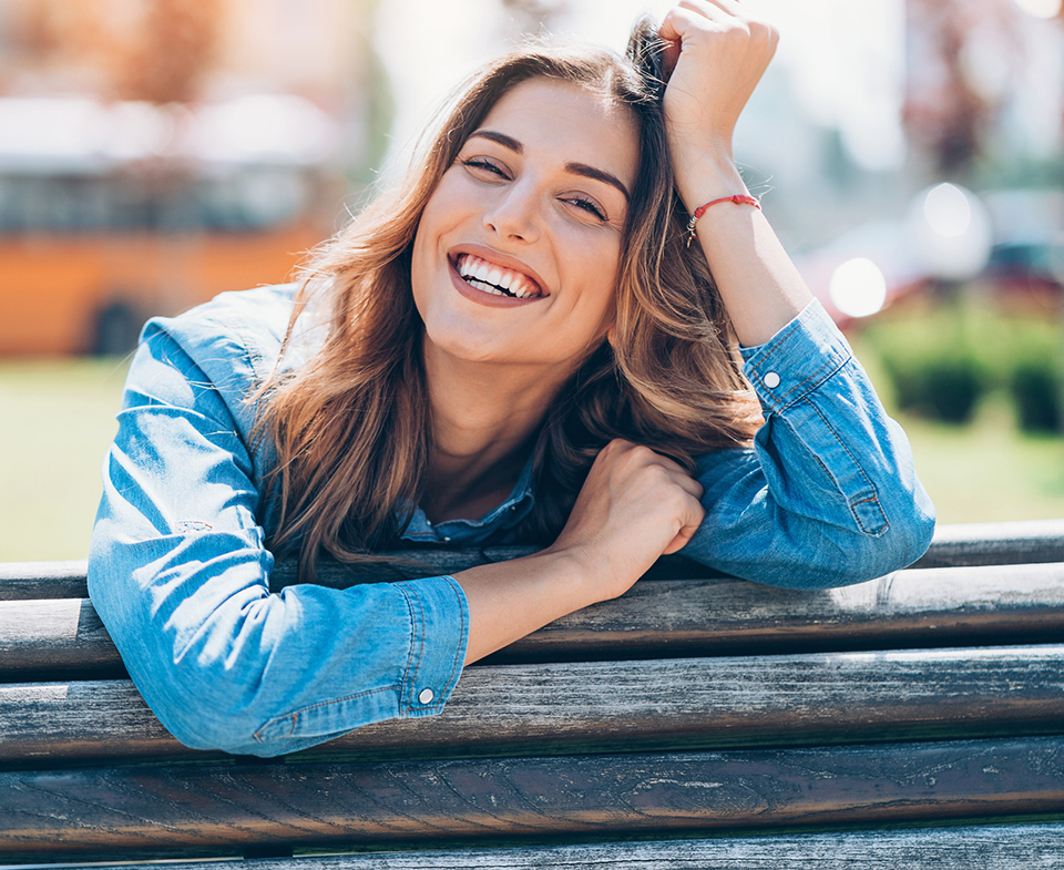 happy woman leaning on fence