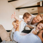 healthy dental habits kids, young family playing together on the couch