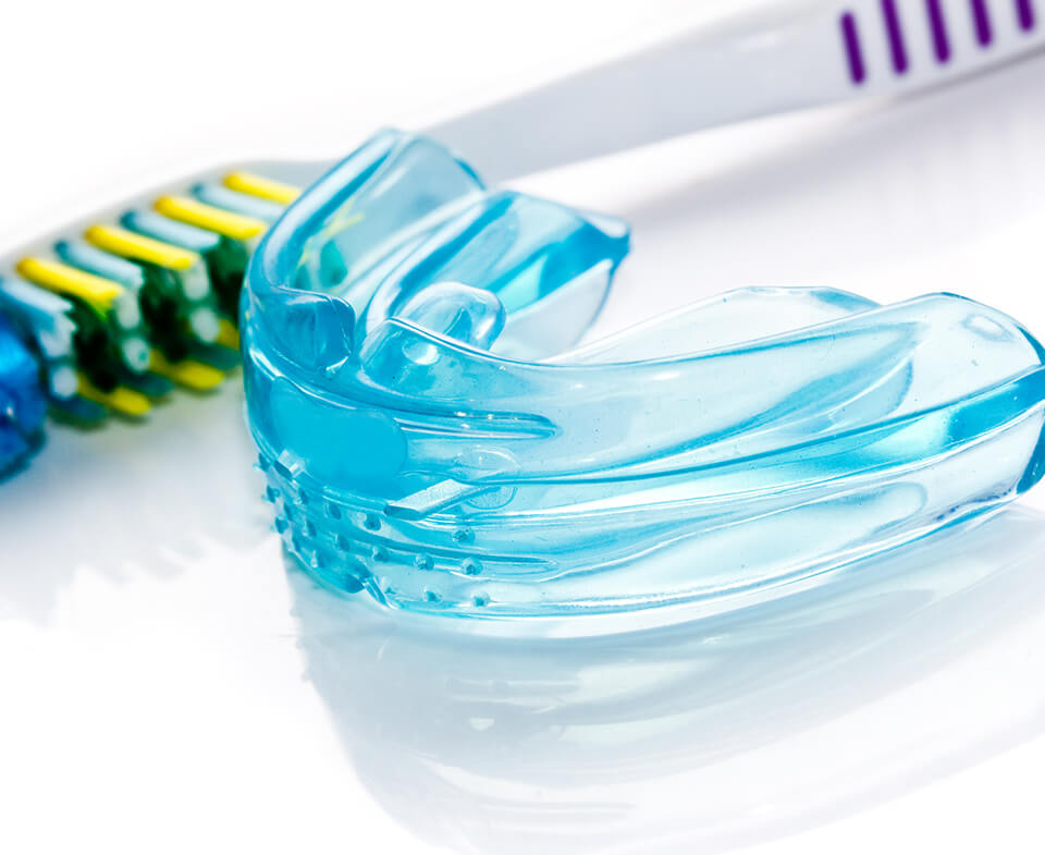 mouthguard next to a toothbrush