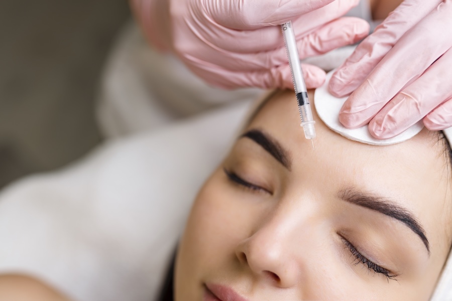 woman getting botox or facial dermal fillers for facial rejuvenation
